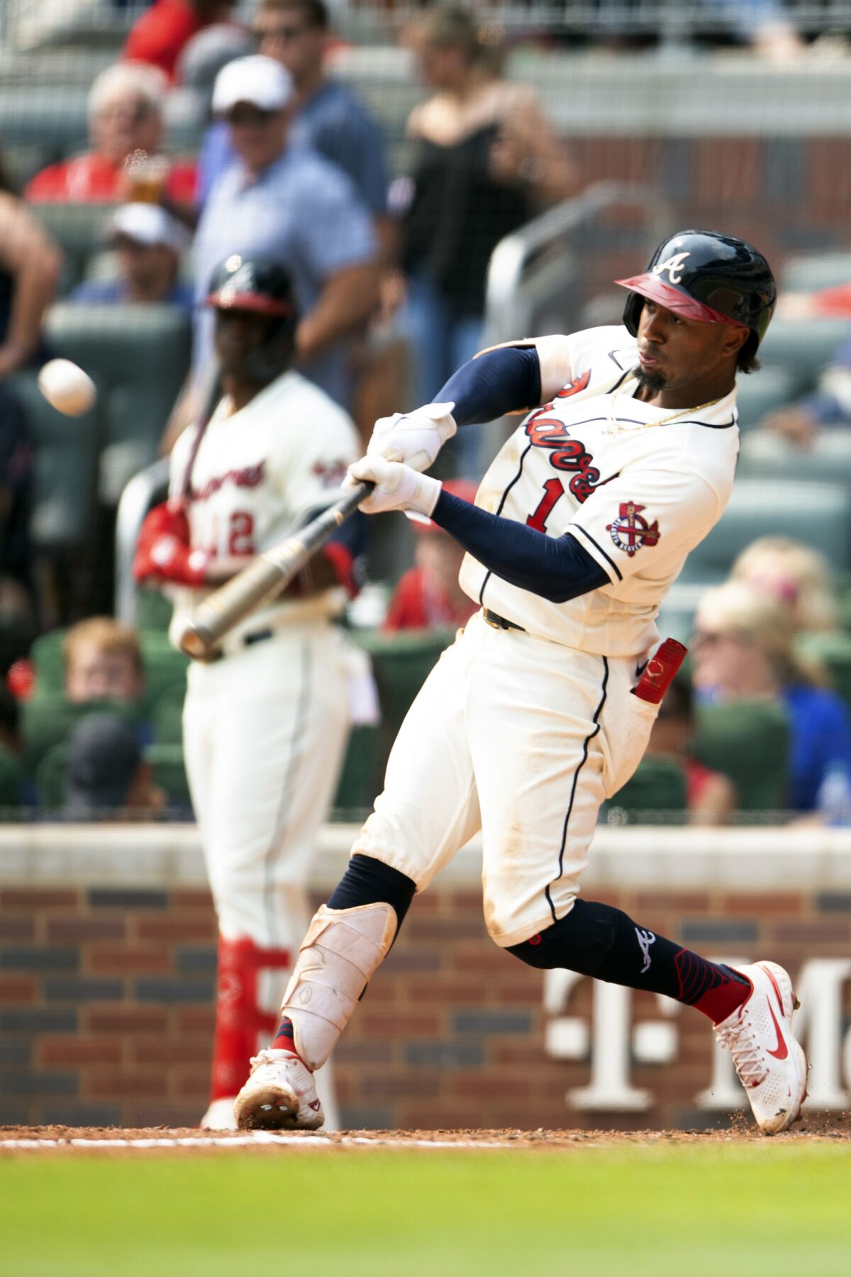 Atlanta Braves' Ozzie Albies (1) hits a pop fly in the fourth inning of a baseball game against the Miami Marlins, Sunday, Sept 12, 2021, in Atlanta. (AP Photo/Hakim Wright Sr)