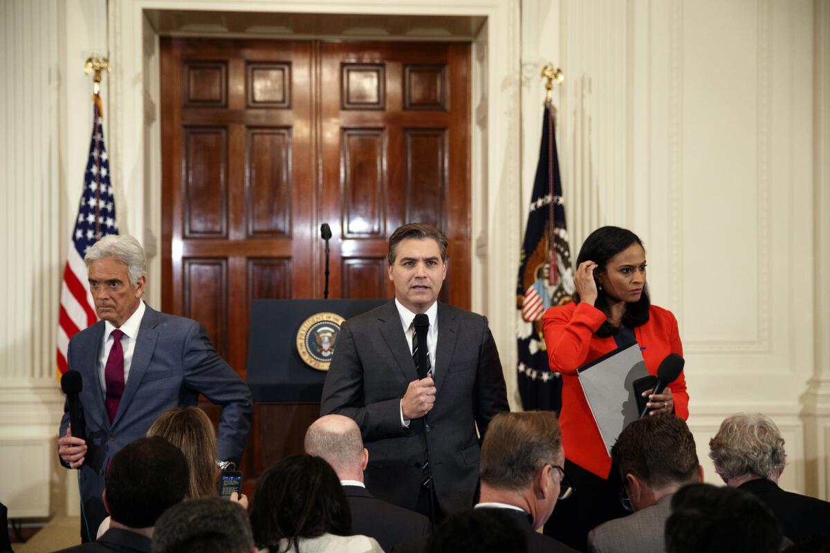 John Roberts of Fox News, left, Jim Acosta of CNN and Kristen Welker of NBC stand in the White House on Nov. 7.