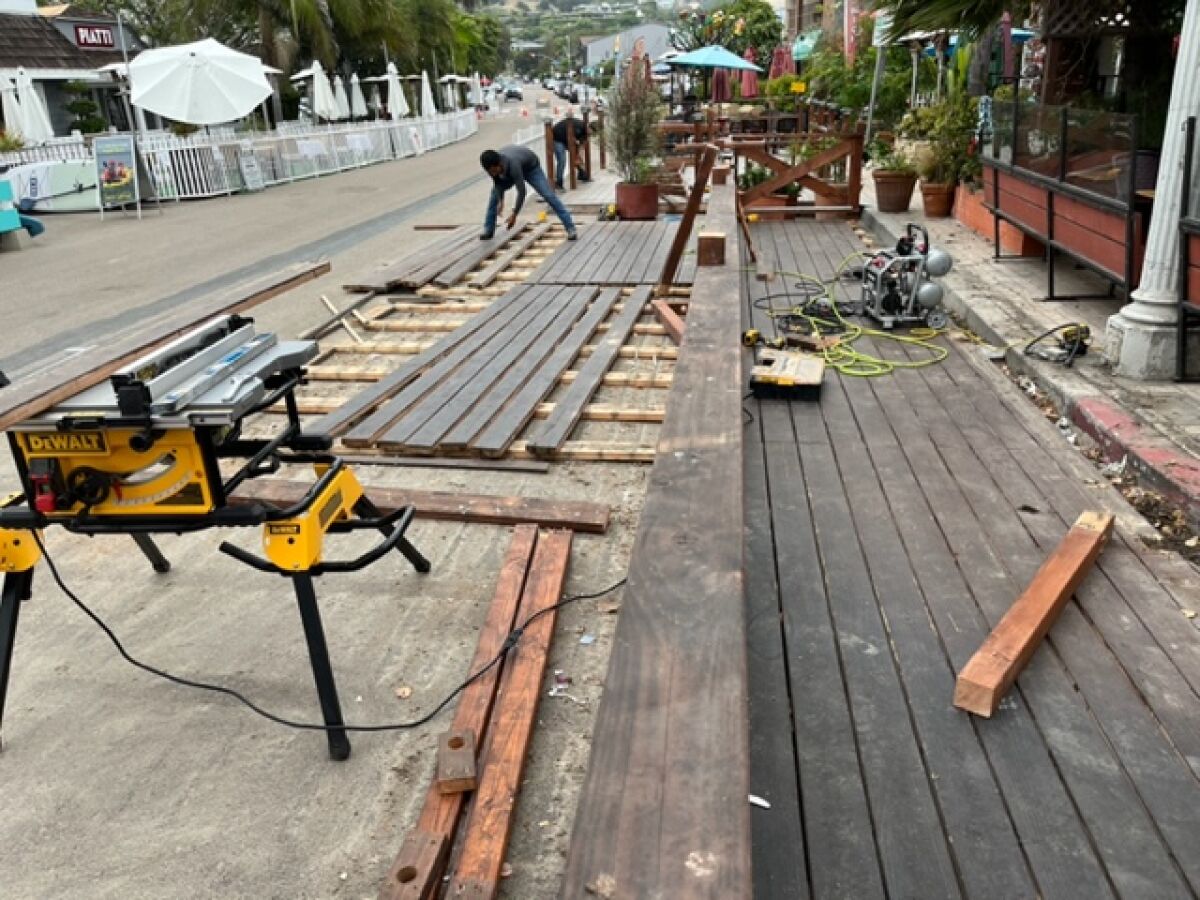 Restaurants in La Jolla Shores work July 18 to reduce their street dining space to comply with new requirements.