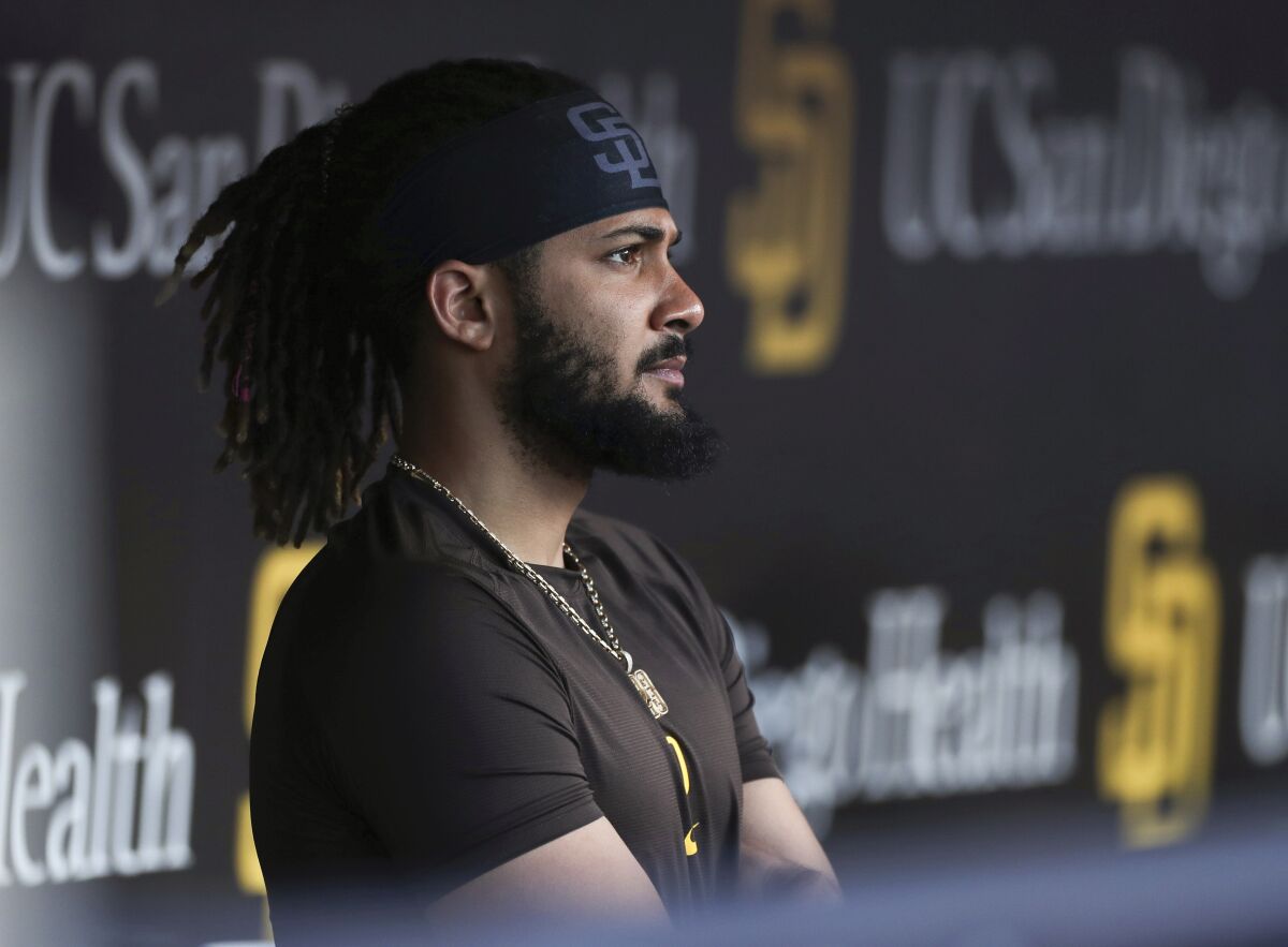 FILE - San Diego Padres' Fernando Tatis Jr. looks out from the dugout prior to the team's baseball game against the Philadelphia Phillies on June 25, 2022, in San Diego. Tatis was suspended 80 games by Major League Baseball on Friday, Aug. 12, after testing positive for a performance-enhancing substance. The penalty was effective immediately, meaning the All-Star shortstop cannot play in the majors this year. Tatis had been on the injured list all season after breaking his left wrist in spring training. (AP Photo/Derrick Tuskan, File)