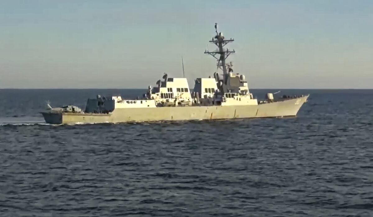 In this photo taken from video released by Russian Defense Ministry Press Service, the U.S. destroyer USS Chafee is seen form Russian navy's Admiral Tributs destroyer near Russian territorial waters in the Sea of Japan on Friday, Oct. 15, 2021. Russia's Defense Ministry says a Russian warship has prevented a U.S. Navy destroyer from what it described as an attempt to intrude into Russian territorial waters in the Sea of Japan. The ministry charged that the Russian navy's Admiral Tributs destroyer closely approached the U.S. destroyer USS Chafee to force it out of the area Friday near Russian waters that was declared off limits to shipping due to a Russian artillery drills. (Russian Defense Ministry Press Service via AP)