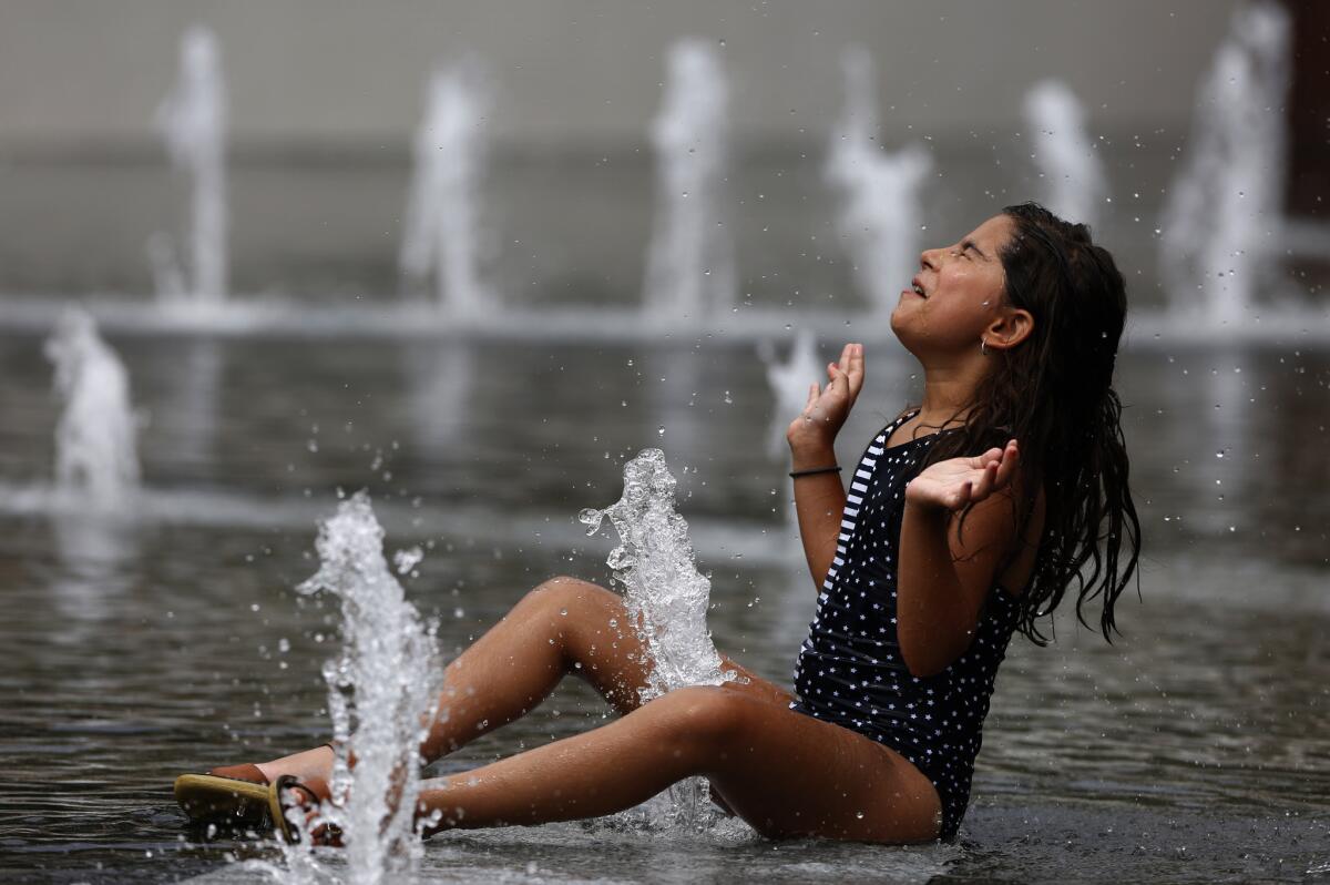 Nooria Retzer cools off at the Grand Park fountain in downtown L.A. during the heat wave.