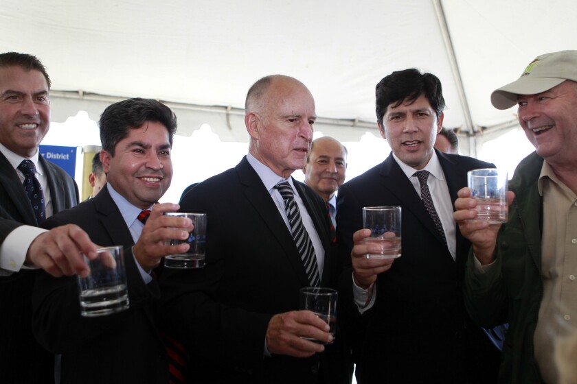 From left: Shawn Dewane, president of the Orange County Water District; former state Assemblyman Jose Solorio, Gov. Jerry Brown; state Sen. Lou Correa; state Senate President Pro Tempore Kevin De León; and Rep. Dana Rohrabacher, toast with glasses of reclaimed water.