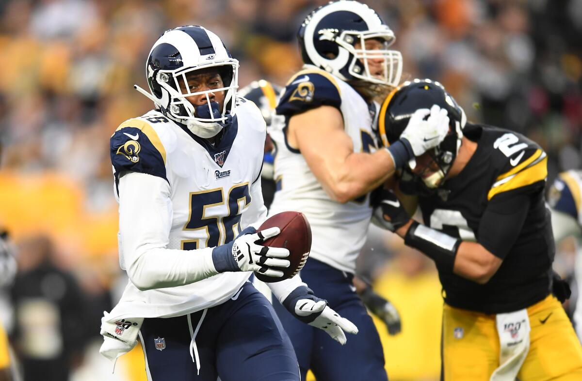 Rams linebacker Dante Fowler Jr. returns a fumble for a touchdown as Steelers quarterback Mason Rudolph is handled by Clay Matthews in Week 10.