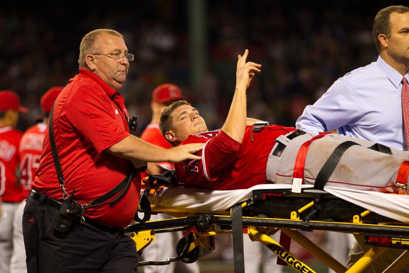 Garrett Richards signals to the fans after he suffered a knee injury against the Boston Red Sox on Aug 20.