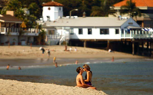 Charlie Yedor, 17, of Sherman Oaks, and Angelica Maleski, 16, of Sherman Oaks, spend a romantic moment on a warm summer day at Surfrider Beach and the Malibu Pier.