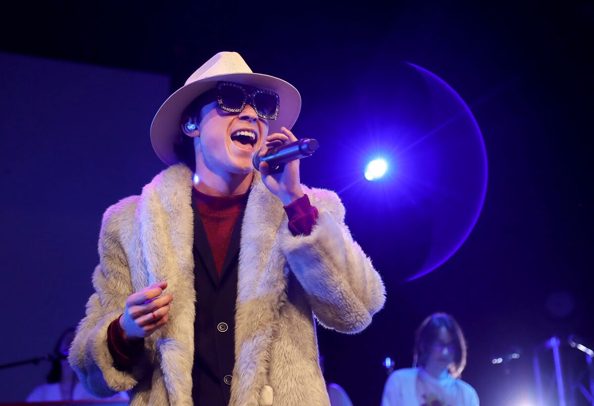 Singer Andre Garcia rehearses for "Playlist," which has three shows this weekend on the Huntington Beach High campus.