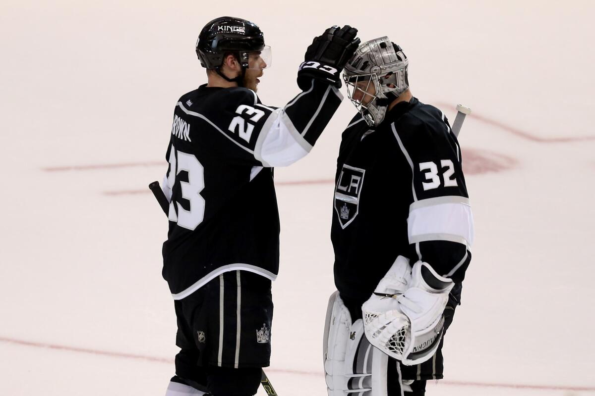 "A lot has been said about his play. I think us players view his play a lot differently ... because we see him on a day-in, day-out basis and the saves he has made that allow us to be playing this time of year," the Kings' Dustin Brown, left, said of teammate Jonathan Quick.