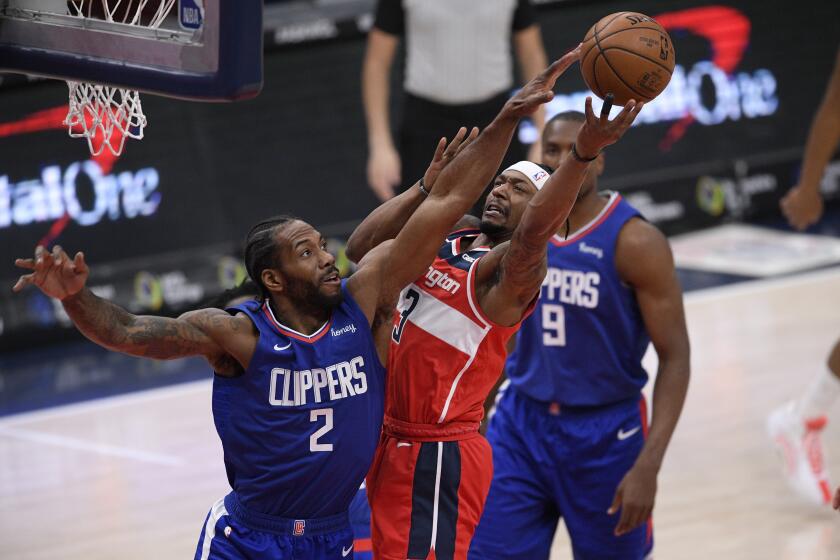 Washington Wizards guard Bradley Beal (3) goes to the basket against Los Angeles Clippers forward Kawhi Leonard (2) during the first half of an NBA basketball game, Thursday, March 4, 2021, in Washington. Leonard was called for a foul on the play. (AP Photo/Nick Wass)