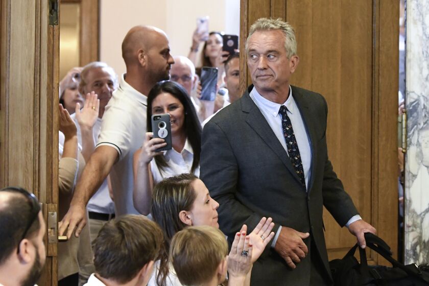 FILE - Robert F. Kennedy, Jr. arrives for a hearing about whether stricter vaccine requirements were constitutional at the Albany County Courthouse Wednesday, Aug. 14, 2019, in Albany, N.Y. Kennedy has been a key part of the anti-vaccine movement for years, but doctors and public health advocates told the AP that COVID-19 launched him to a new level. (AP Photo/Hans Pennink, File)