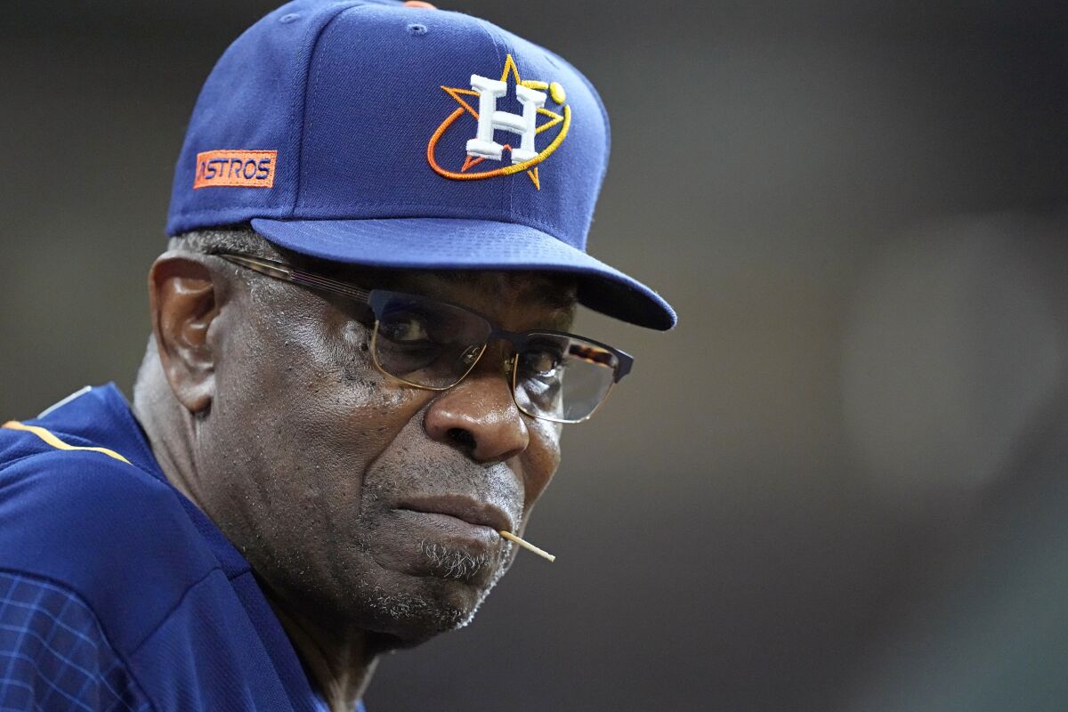 Houston Astros manager Dusty Baker Jr. watches from the dugout during the sixth inning of a baseball game against the Seattle Mariners Monday, May 2, 2022, in Houston. (AP Photo/David J. Phillip)
