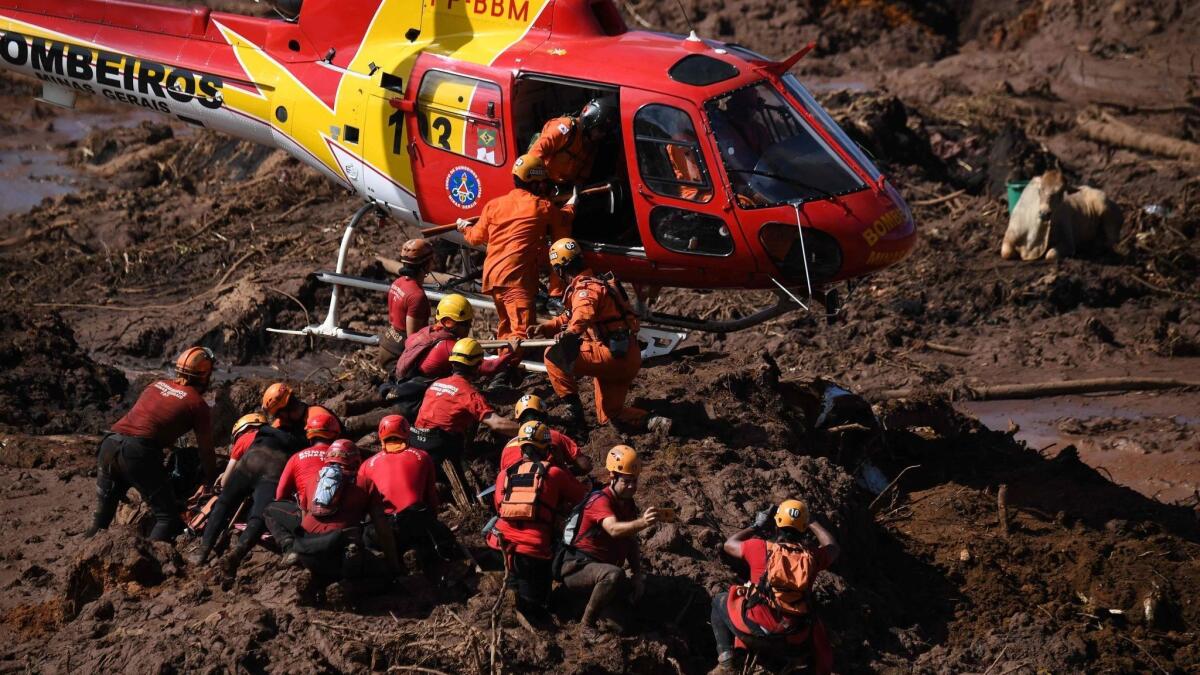 Firefighters and other first responders search for victims, three days after the collapse of a dam at an iron ore mine belonging to Brazil's giant mining company Vale.