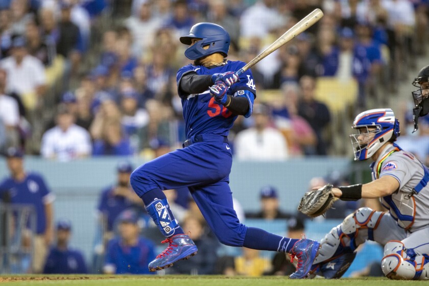 The Dodgers' Mookie Betts hits a three-run double in the second inning. Mets catcher Patrick Mazeika is at right.