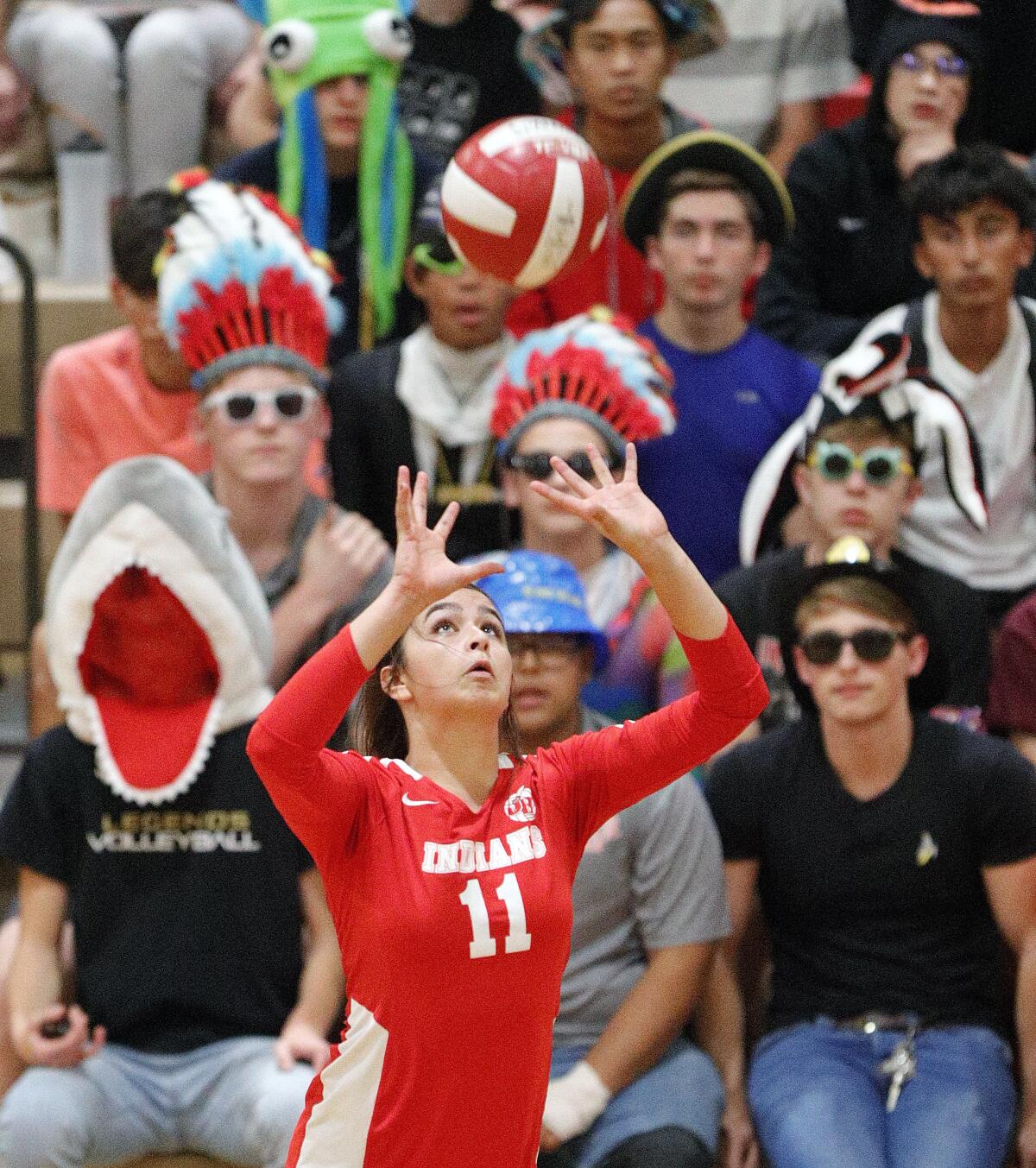 Burroughs' Catie Virtue, with many Burroughs fans in Halloween costumes, sets the ball for a kill against Murrieta Valley in a CIF Division II playoff girls' volleyball match at Burroughs High School on Thursday, October 24, 2019. Murrieta Valley won the match 3-0.