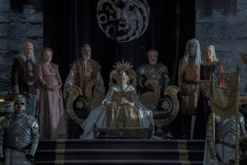 A group of royals flanking the king seated in his throne.