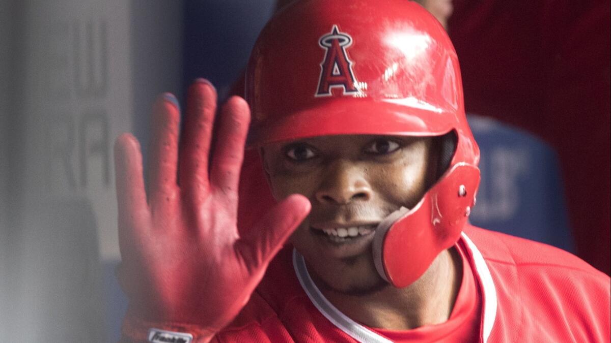 Angels left fielder Justin Upton celebrates in the dugout after hitting a home run against the Toronto Blue Jays on June 17.