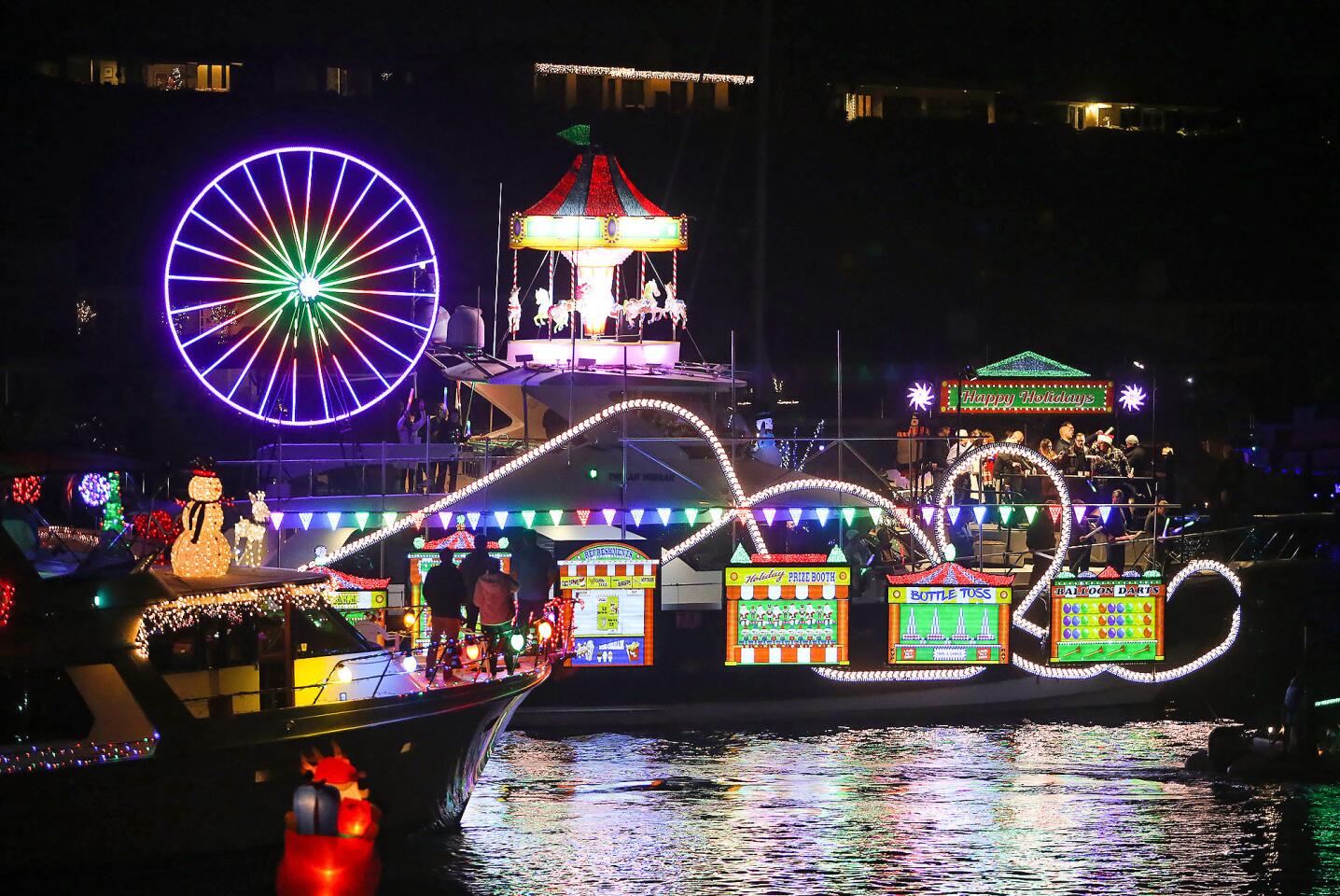 A colorful boat decorated in the theme of a circus lights up the Balboa Bridge turnaround during the 110th Newport Beach Christmas Boat Parade on Wednesday night. The parade runs nightly through Sunday, starting at about 6:30 p.m. from the southern end of Lido Isle.