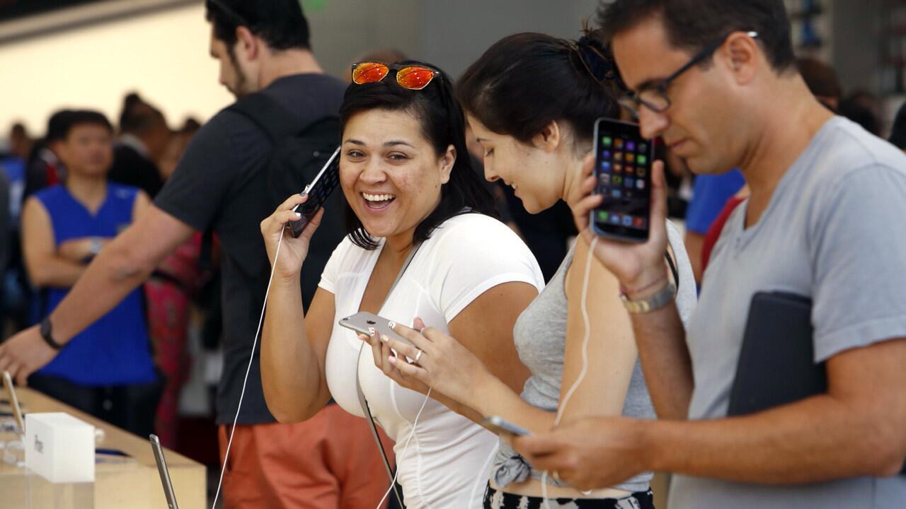 Erika Castillo, left, and Dan Unger, right, check out the iPhone 6 Plus at the Apple Store in Santa Monica.