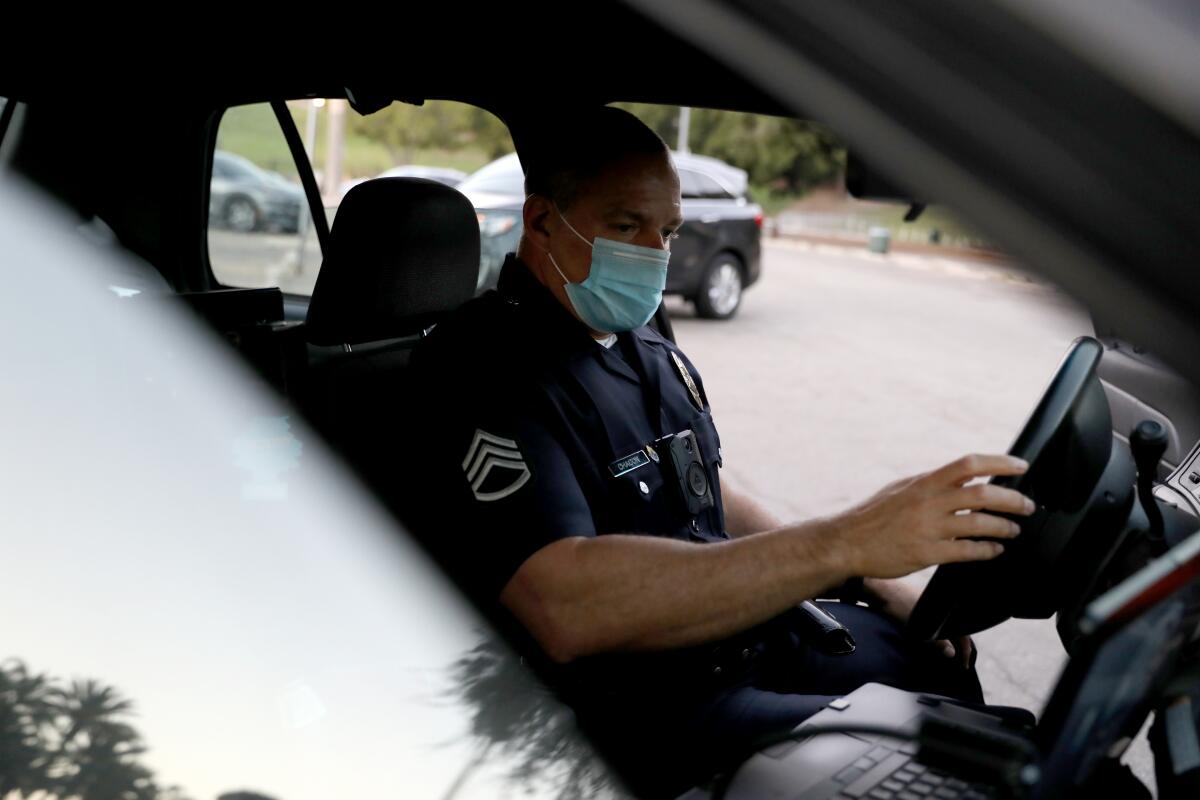 LAPD Sgt. Jaime Chacon sits in a police car