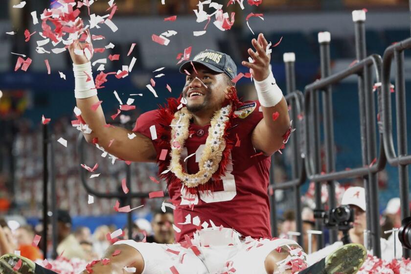 FILE - In this Dec. 30, 2018, file photo, Alabama quarterback Tua Tagovailoa throws confetti in the air after winning the Orange Bowl NCAA college football game against Oklahoma, in Miami Gardens, Fla. Tagovailoa had to settle for second place in the Heisman Trophy balloting, but he delivered arguably the best bowl performance of any player in the country. Tagovailoa outdueled Heisman Trophy winner Kyler Murray of Oklahoma in the Sugar Bowl to earn his spot as the quarterback of our all-bowl team. (AP Photo/Wilfredo Lee, File)