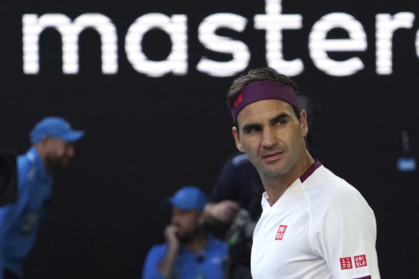 Switzerland's Roger Federer reacts after defeating Tennys Sandgren of the U.S. in their quarterfinal match at the Australian Open tennis championship in Melbourne, Australia, Tuesday, Jan. 28, 2020. (AP Photo/Lee Jin-man)