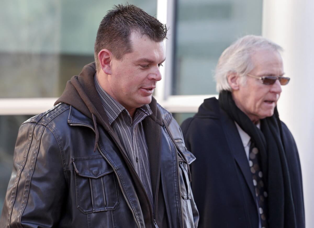 Eric Jensen, 37, leaves the federal courthouse in Denver with attorney Forrest Lewis after he and his brother Ryan were sentenced to five years of probation and six months of home detention. The two Colorado cantaloupe farmers pleaded guilty to misdemeanor charges stemming from a deadly listeria outbreak in 2011.