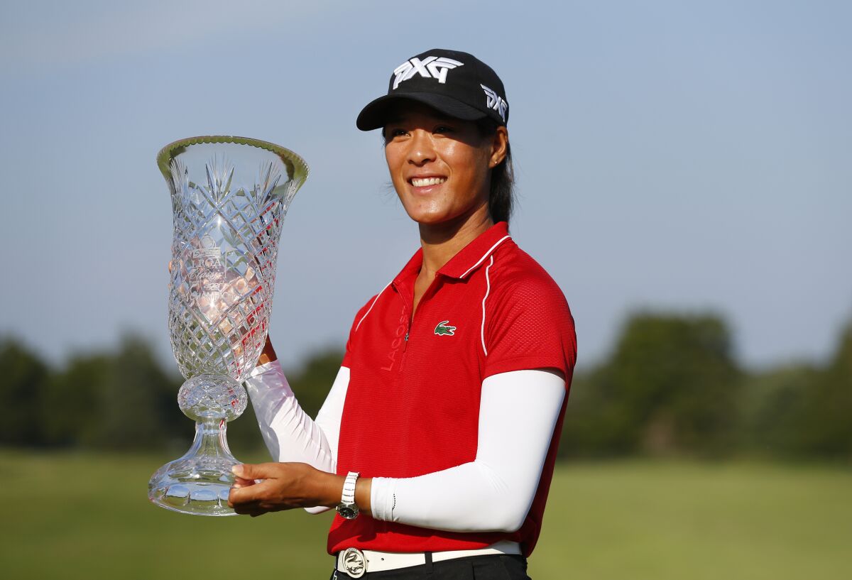 Celine Boutier, of France, celebrates after winning the Shop Rite LPGA Classic tournament, Sunday, Oct 3, 2021, in Galloway, N.J. (AP Photo/Noah K. Murray)