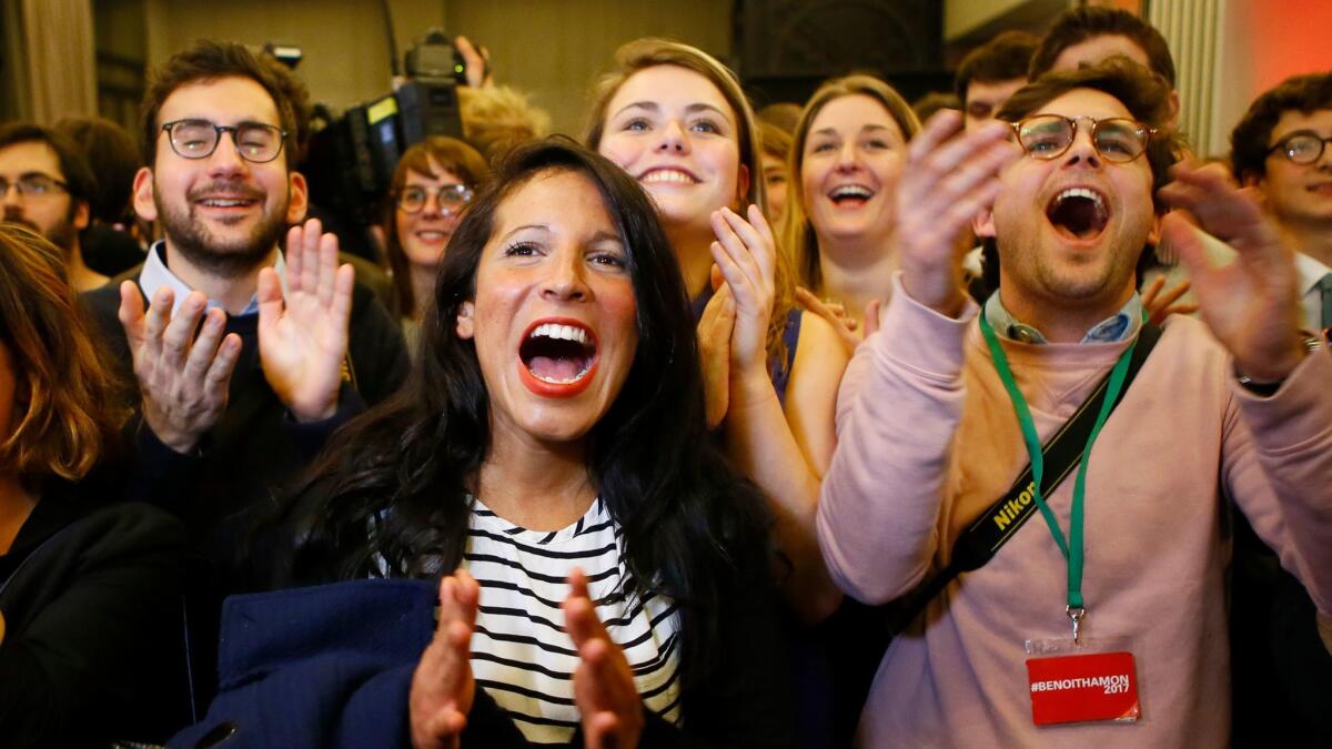 Supporters of Benoit Hamon celebrate at a gathering in Paris after their candidate won the Socialist Party presidential nomination on Sunday.