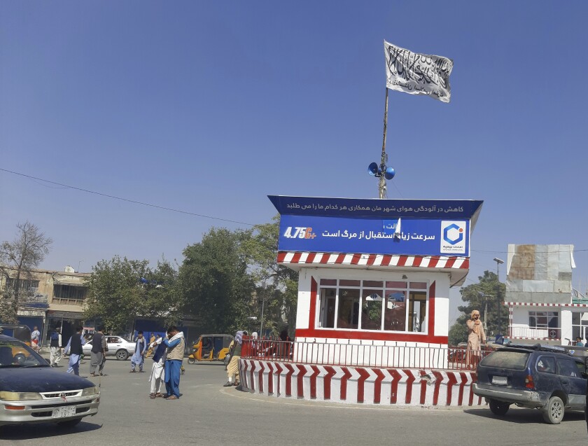 A Taliban flag flies in a city square in Kunduz, Afghanistan