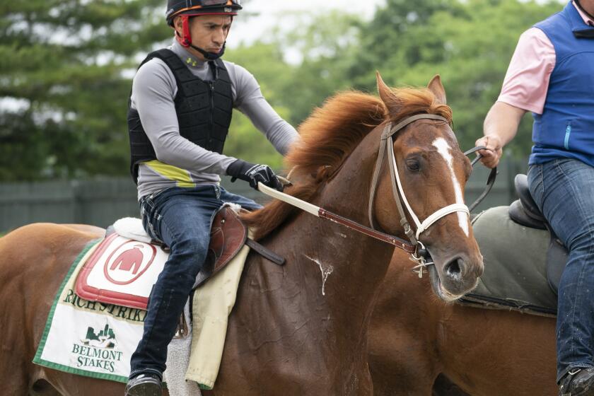 Rich Strike walks off the track after training before the 154th running.