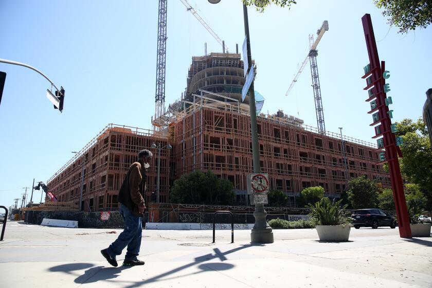 LOS ANGELES, CA - APRIL 23, 2020: Construction is underway at 2900 Wilshire Blvd., a $300 million high-rise apartment complex in Koreatown on April 23, 2020, in Los Angeles, California. ({Dania Maxwell} / {Los Angeles Times})
