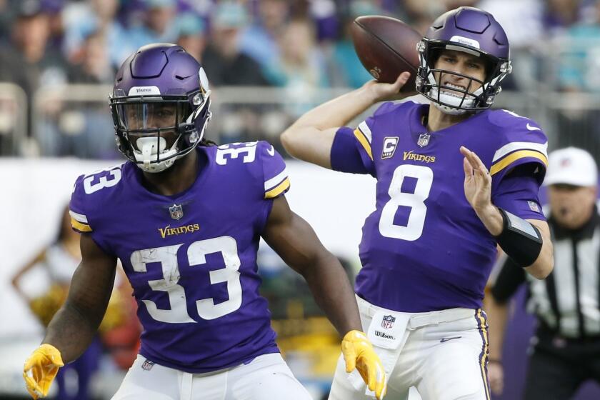 Minnesota Vikings quarterback Kirk Cousins (8) throws a pass as teammate Dalvin Cook (33) blocks during the first half of an NFL football game against the Miami Dolphins, Sunday, Dec. 16, 2018, in Minneapolis. (AP Photo/Bruce Kluckhohn)