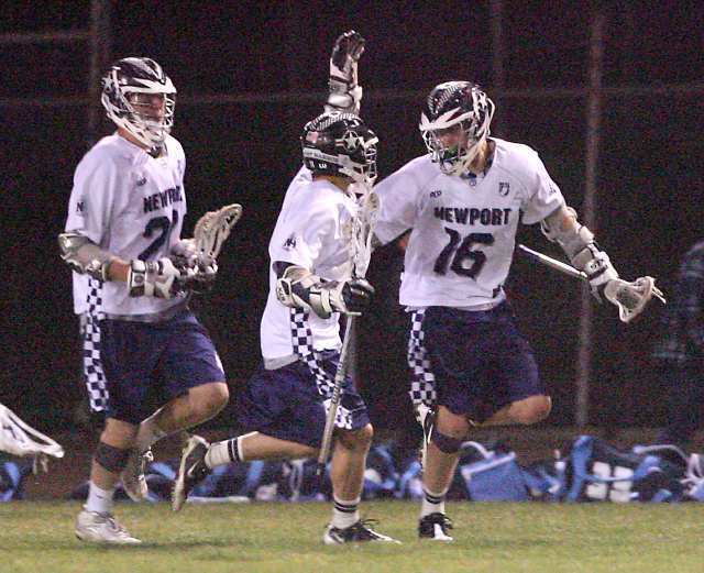 From left, Newport Harbor's Brian Team and Park Eddy congratulate Matt Buchanan after he scored against Corona del Mar during the Battle of the Bay lacrosse match at Newport Harbor High School on Friday.