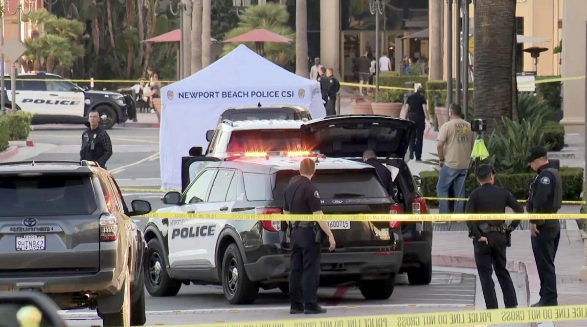 Police set up a crime scene at Fashion Island mall in Newport Beach after a tourist was killed in a robbery attempt.
