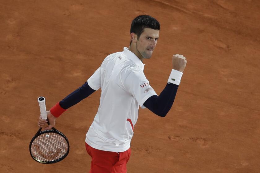 Serbia's Novak Djokovic clenches his fist after scoring a point against Spain's Pablo Carreno Busta in the quarterfinal match of the French Open tennis tournament at the Roland Garros stadium in Paris, France, Wednesday, Oct. 7, 2020. (AP Photo/Alessandra Tarantino)