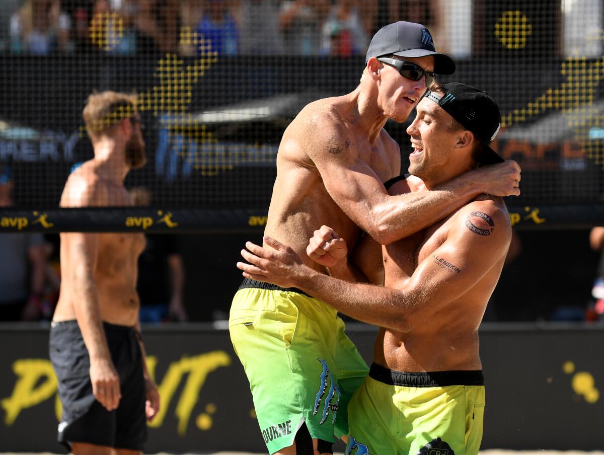 Tri Bourne, left, and Trevor Crabb celebrate their championship win at the AVP Manhattan Beach Open on Sunday.