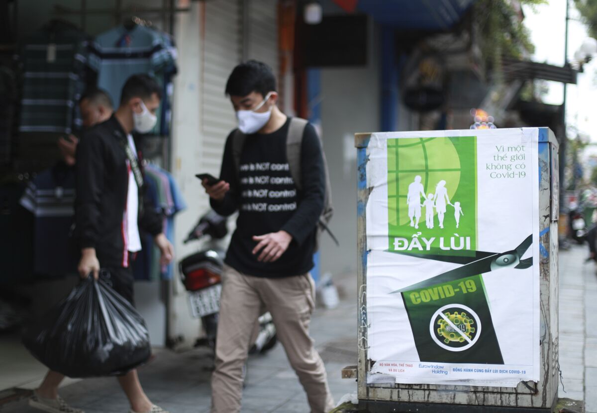 A poster in Hanoi reads "Fighting COVID-19," in Vietnamese. Many business activities resumed Thursday as Vietnam lifted a nationwide lockdown to contain the spread of COVID-19.