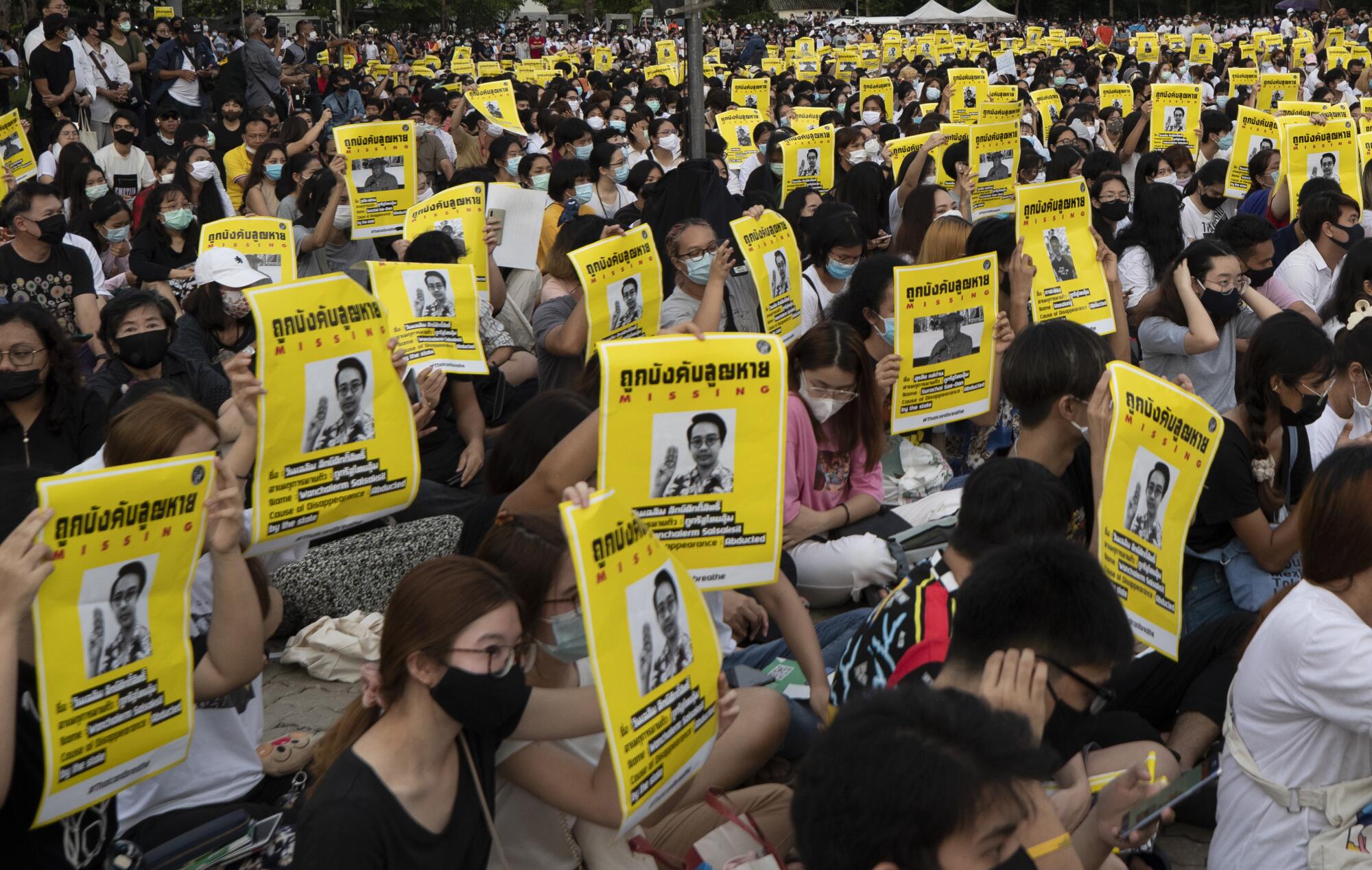 Pro-democracy students hold posters of Wanchalearm Satsaksit during a protest in Bangkok