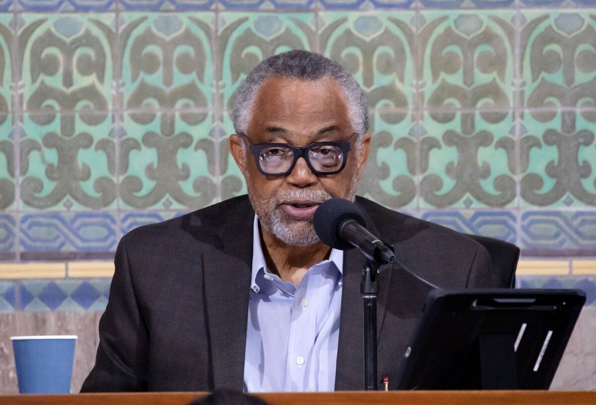 A man speaks into a microphone.