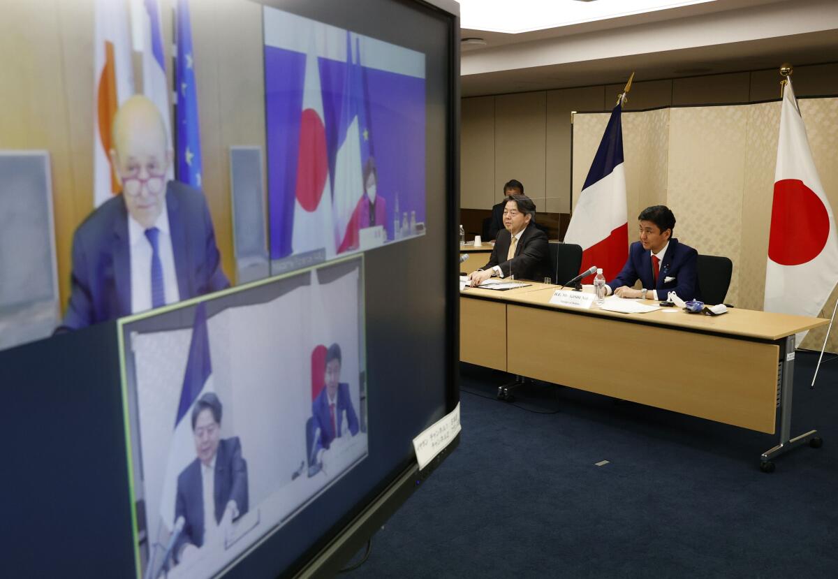Japan's Foreign Minister Yoshimasa Hayashi, centre and Defense Minister Nobuo Kishi,participate in a video conference with France's Foreign Minister Jean-Yves Le Drian and Defence Minister Florence Parly, at the Foreign Ministry in Tokyo, Japan, Thursday, Jan. 20, 2022. Foreign and defense ministers from Japan and France held their virtual talks Thursday as the two countries seek to deepen their security ties in the Indo-Pacific where tension rises amid China’s military buildup and North Korea’s missile advancement. (Issei Kato/Pool via AP)