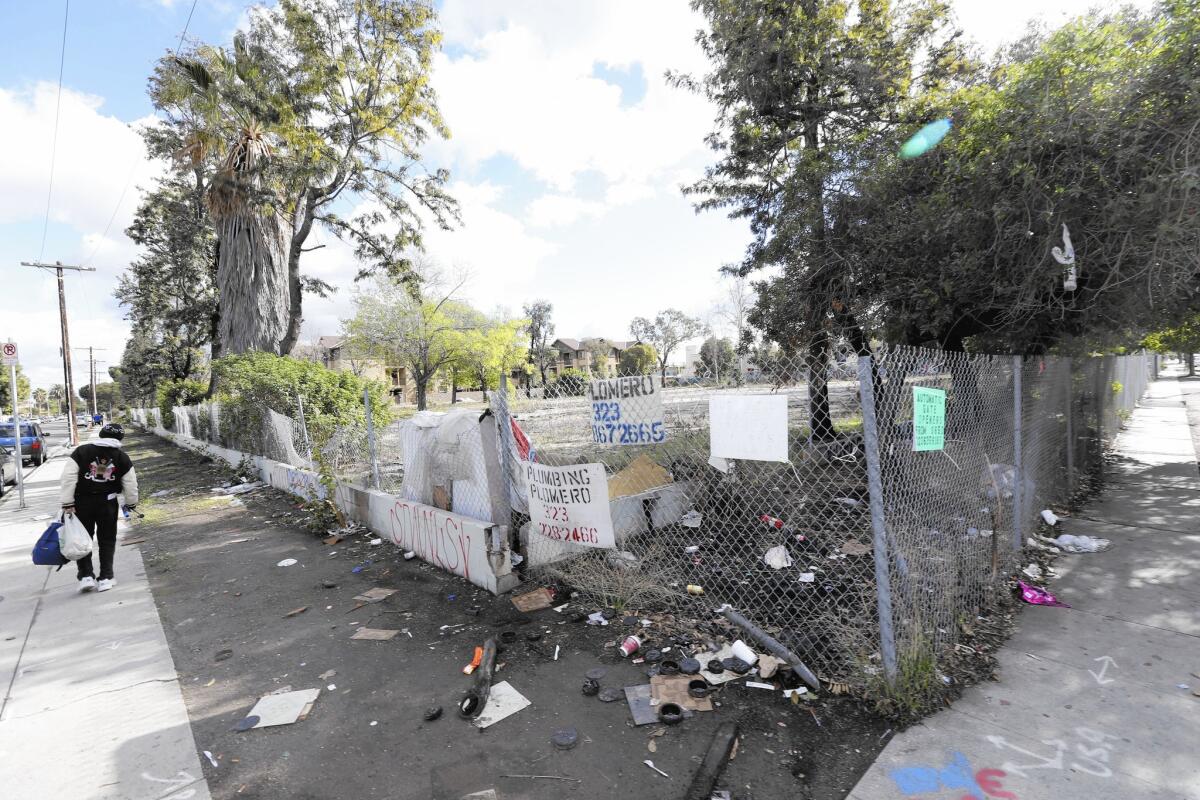 The long-vacant lot at 94th Street and Broadway in South L.A. is strewn with trash after grocer Numero Uno backed out of a deal to add a store there.