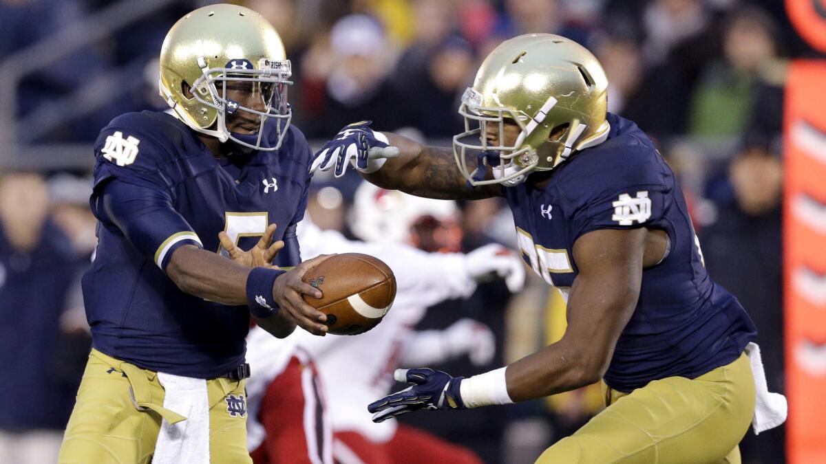 Notre Dame quarterback Everett Golson hands off the ball to running back Tarean Folston during a loss to Louisville. The Irish will try to end a five-game losing streak in the Music City Bowl on Tuesday.