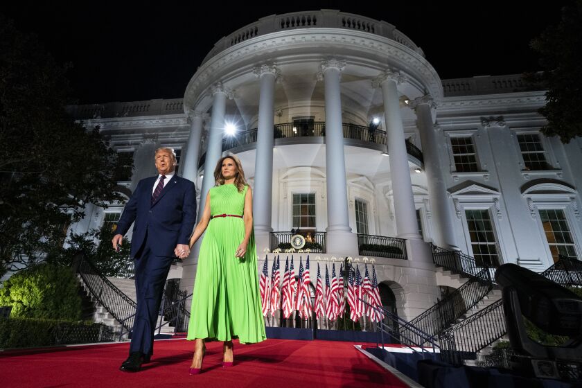 President Donald Trump and first lady Melania Trump arrive on the South Lawn of the White House for the fourth day of the Republican National Convention, Thursday, Aug. 27, 2020, in Washington. (AP Photo/Evan Vucci)