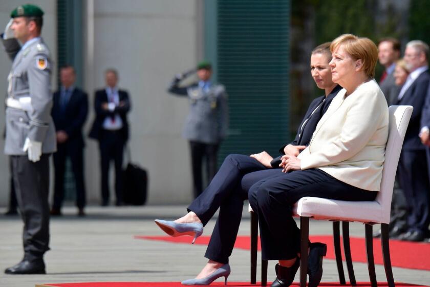 TOPSHOT - German Chancellor Angela Merkel (R) and Denmark's Prime Minister Mette Frederiksen sit as they listen to the national anthems during a welcoming ceremony with military honours on July 11, 2019 in the courtyard of the Chancellery in Berlin. - German Chancellor Angela Merkel had suffered her third trembling spell in less than a month the day before, on July 10, 2019. It had focused attention on her health, after she began shaking involuntarily as national anthems were being played at the reception of the Finnish Prime Minister. (Photo by Tobias SCHWARZ / AFP)TOBIAS SCHWARZ/AFP/Getty Images ** OUTS - ELSENT, FPG, CM - OUTS * NM, PH, VA if sourced by CT, LA or MoD **