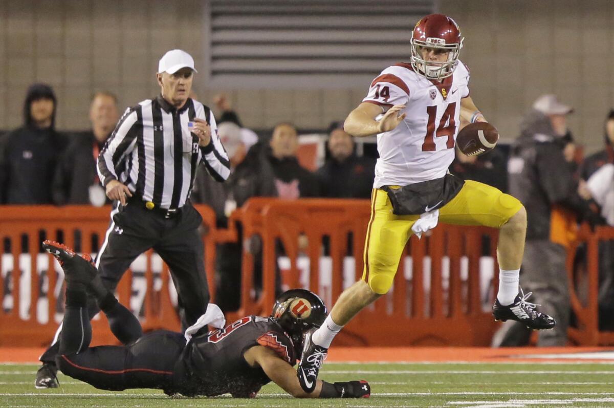 USC quarterback Sam Darnold (14) outruns Utah linebacker Sunia Tauteoli in the second half Friday.