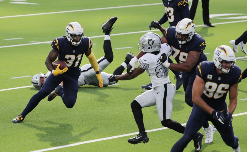 Chargers running back Kalen Ballage cuts through the Las Vegas Raiders defense.