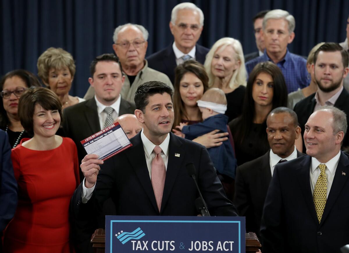 Speaker of the House Paul D. Ryan (R-Wis.), surrounded by families and members of the House Republican leadership, introduces a tax bill.