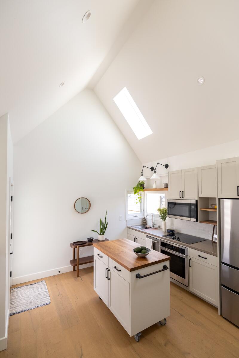 A kitchen with vaulted ceilings and skylights.