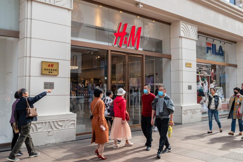 SHANGHAI, CHINA - MARCH 24, 2021 - Citizens walk past an H&M store on Nanjing Road pedestrian street in Shanghai, China, March 24, 2021. (Photo credit should read Costfoto/Barcroft Media via Getty Images)