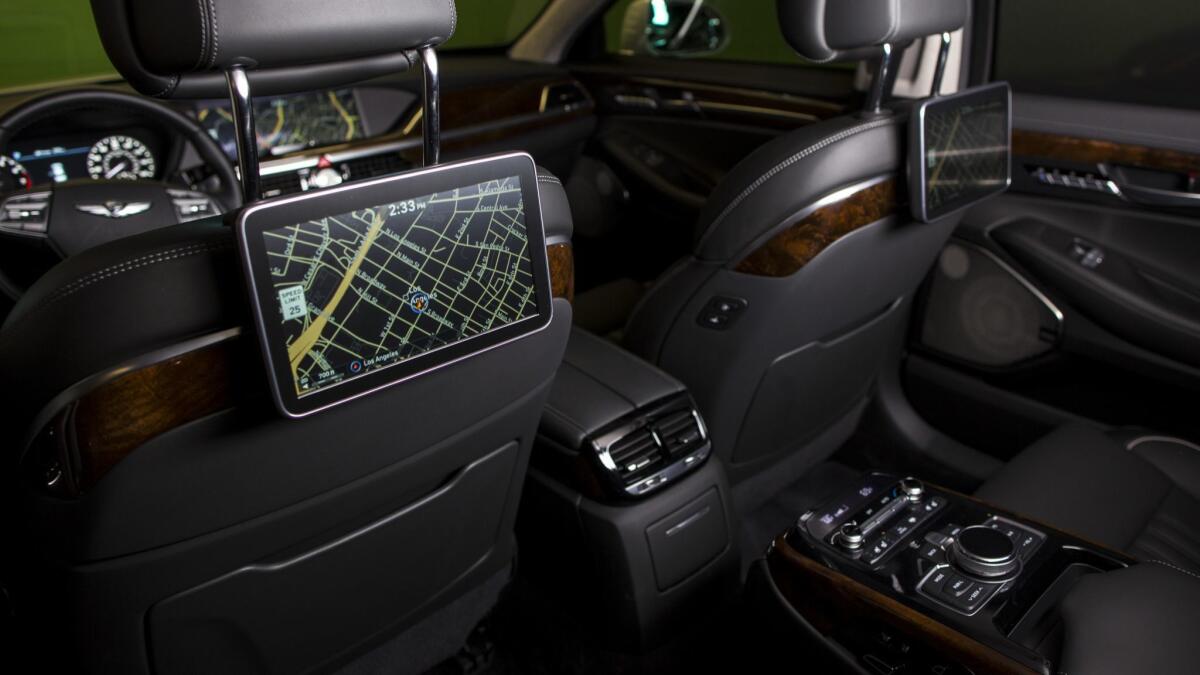 There are ribbons of wood in the G90's interior, and 10.3-inch monitors for backseat occupants.